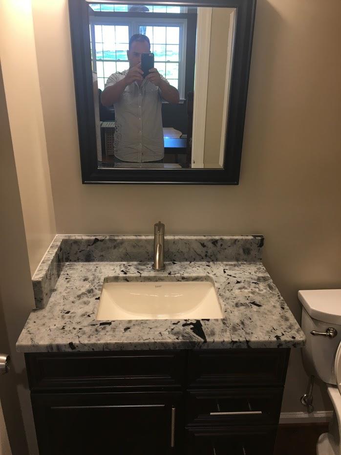 Finished bathroom sink and mirror installation