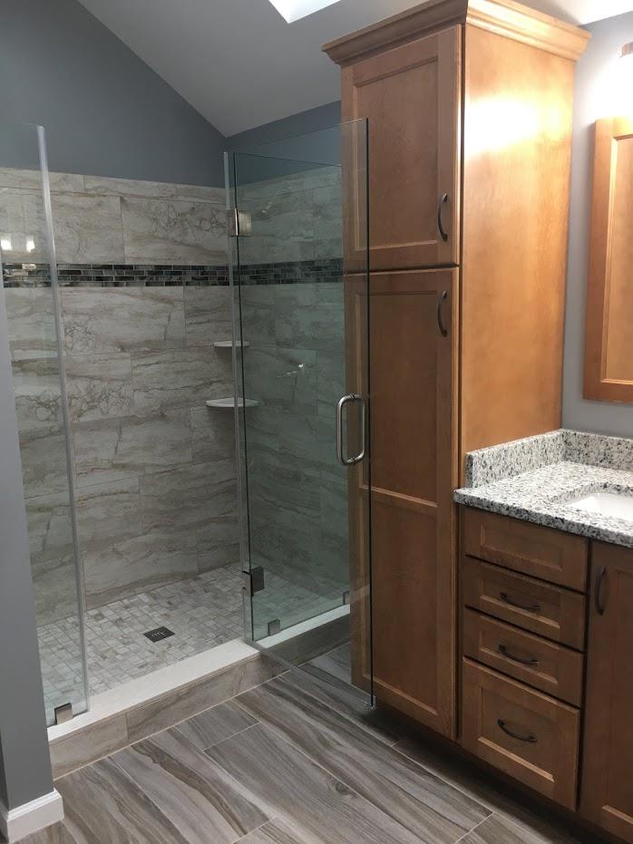 shower room with glass walls adn wooden cabinets