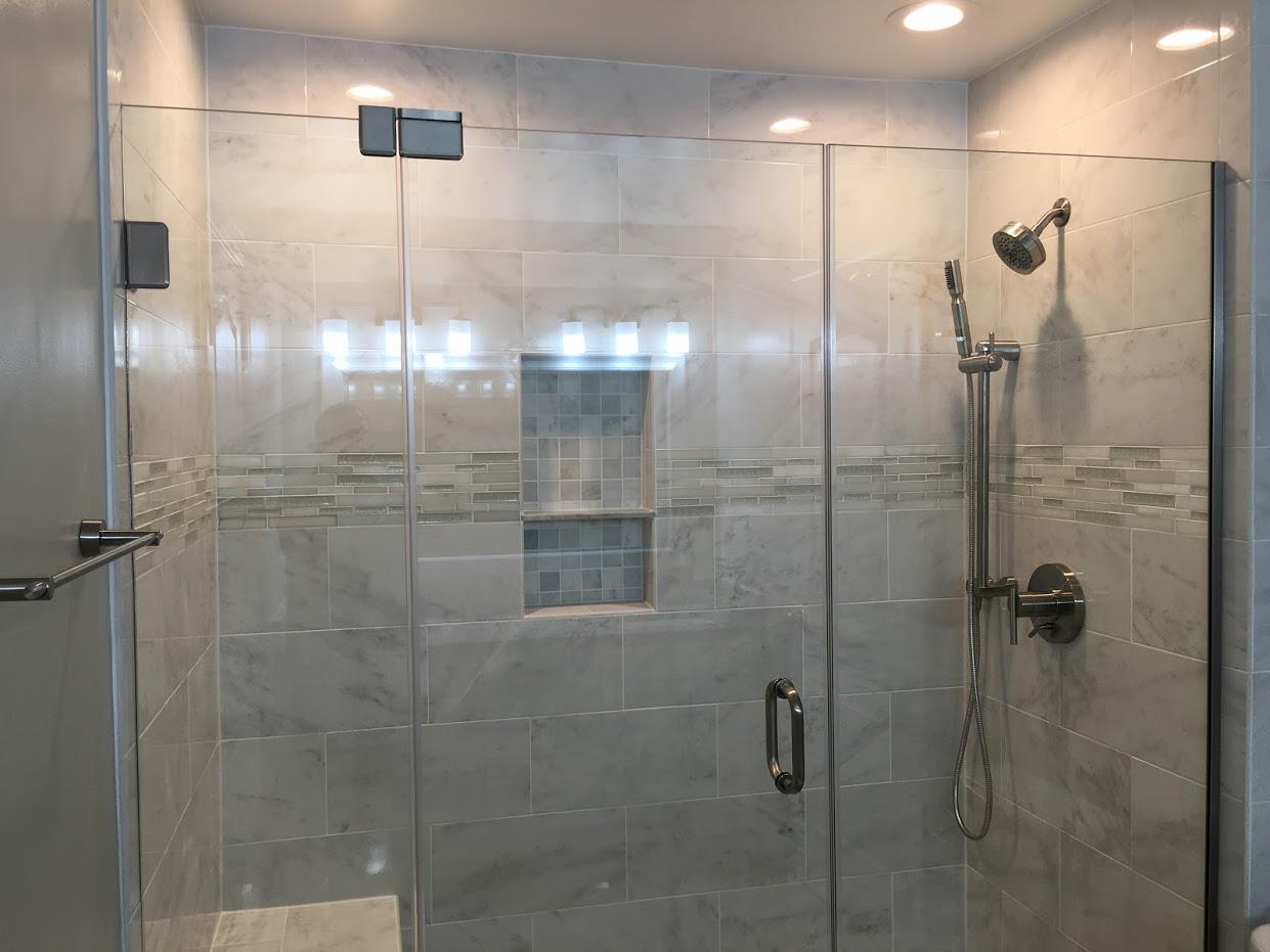 shower room with glass doors and lighting