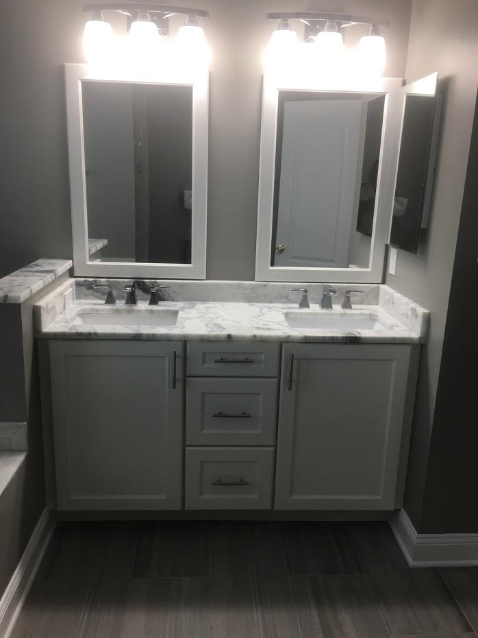 powder room setup with double mirrors and sink