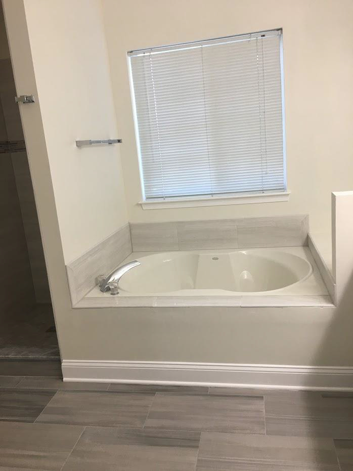 small bath tub near window