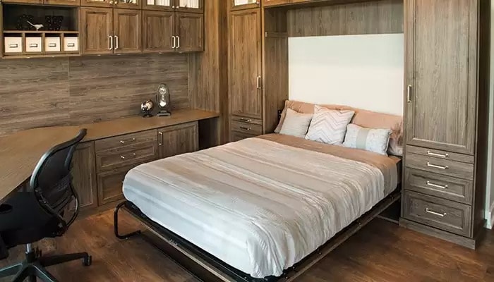 Bedroom for overnight guests using wall bed with hide away desk