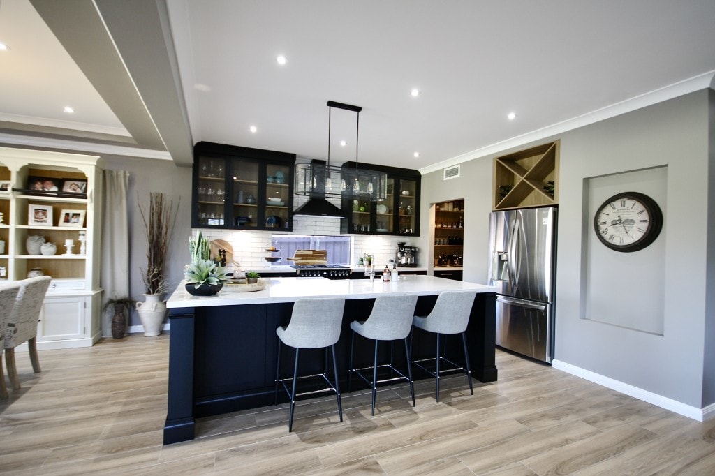 Silestone Countertop with wooden cabinets and white chairs