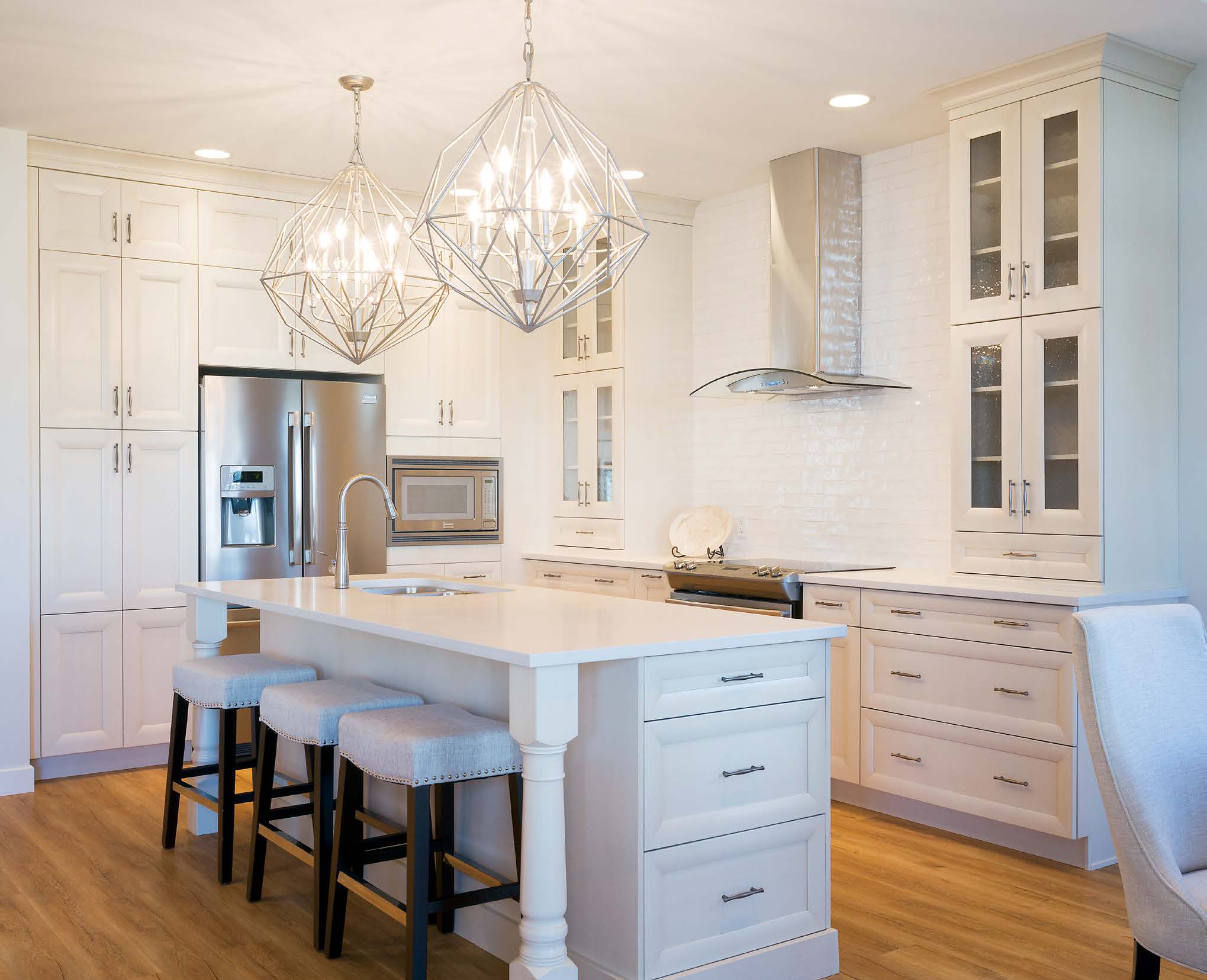 Vista all white kitchen cabinets with artistic lighting fixture